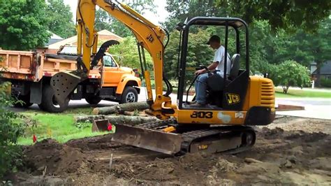 grading with mini excavator|digging with an excavator.